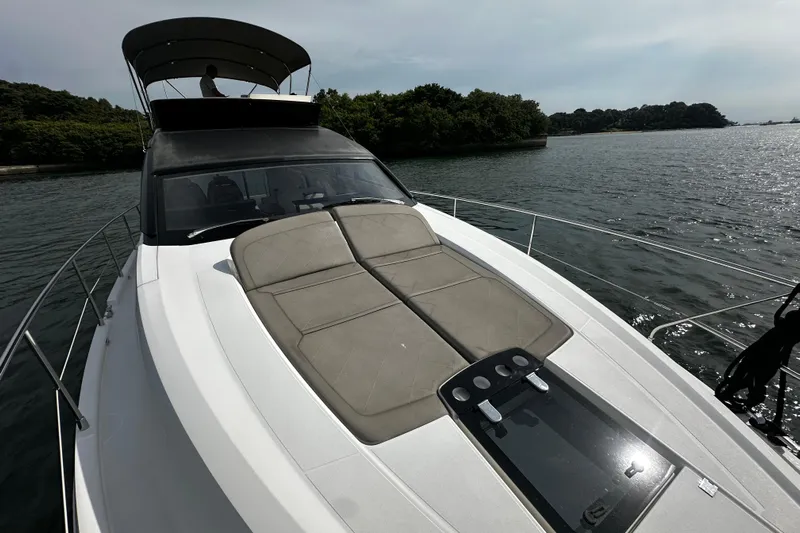  Yacht Photos Pics 2023 Fairline Squadron 50 yacht on water, featuring spacious deck and sleek design.