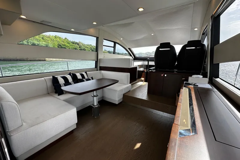  Yacht Photos Pics Luxurious interior of 2023 Fairline Squadron 50 yacht with elegant seating and scenic views.