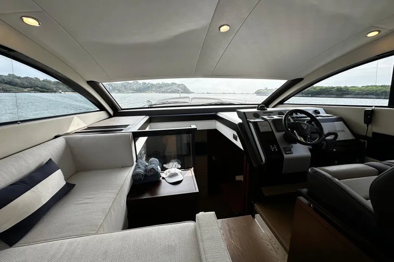  Yacht Photos Pics Interior of 2023 Fairline Squadron 50 yacht, featuring luxurious seating and modern helm.