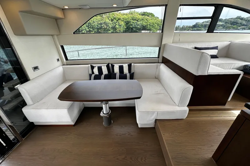  Yacht Photos Pics Luxurious interior of 2023 Fairline Squadron 50 yacht with elegant seating and table.