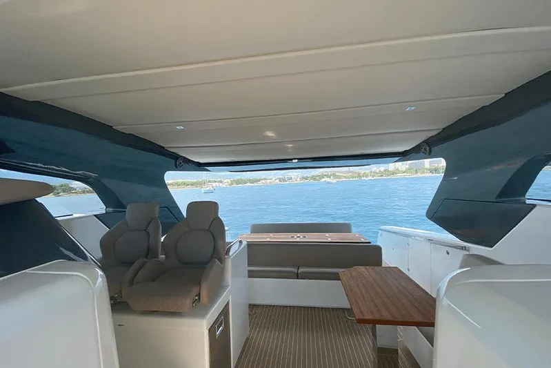  Yacht Photos Pics Interior view of 2025 Makai M37 yacht with modern seating and ocean backdrop.