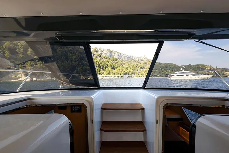  Yacht Photos Pics Interior view of 2025 Makai M37 yacht with scenic water and hills in the background.
