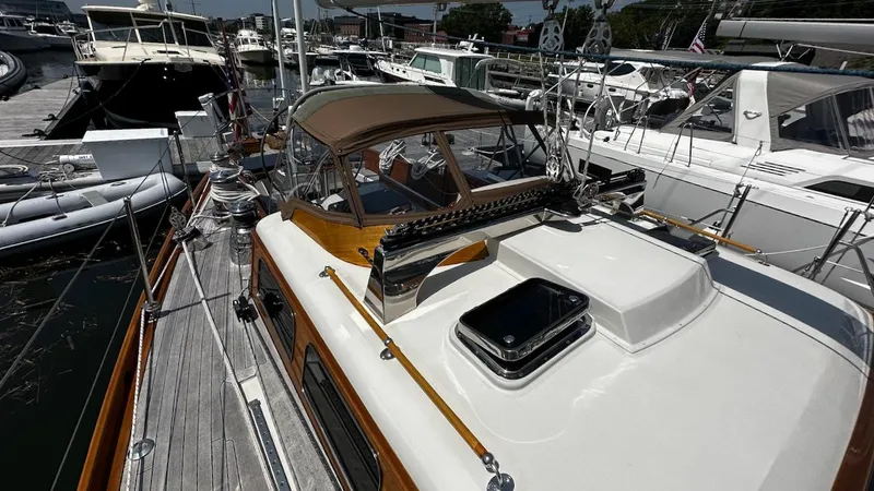Nala Yacht Photos Pics Lyman-Morse Sparkman & Stephens Sloop, 2004, docked with other boats in a marina.
