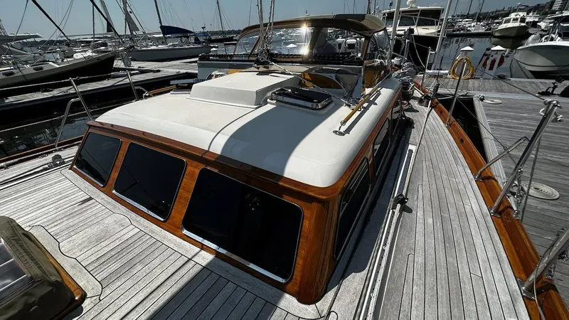 Nala Yacht Photos Pics 2004 Lyman-Morse Sparkman & Stephens Sloop docked, showcasing elegant wooden deck and cabin design.