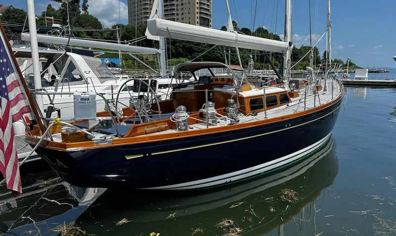 Nala Yacht Photos Pics 2004 Lyman-Morse Sparkman & Stephens Sloop docked in a marina, featuring elegant wooden details.