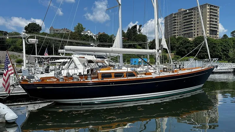 Nala Yacht Photos Pics Lyman-Morse Sparkman & Stephens Sloop, 2004, docked in a marina with scenic background.