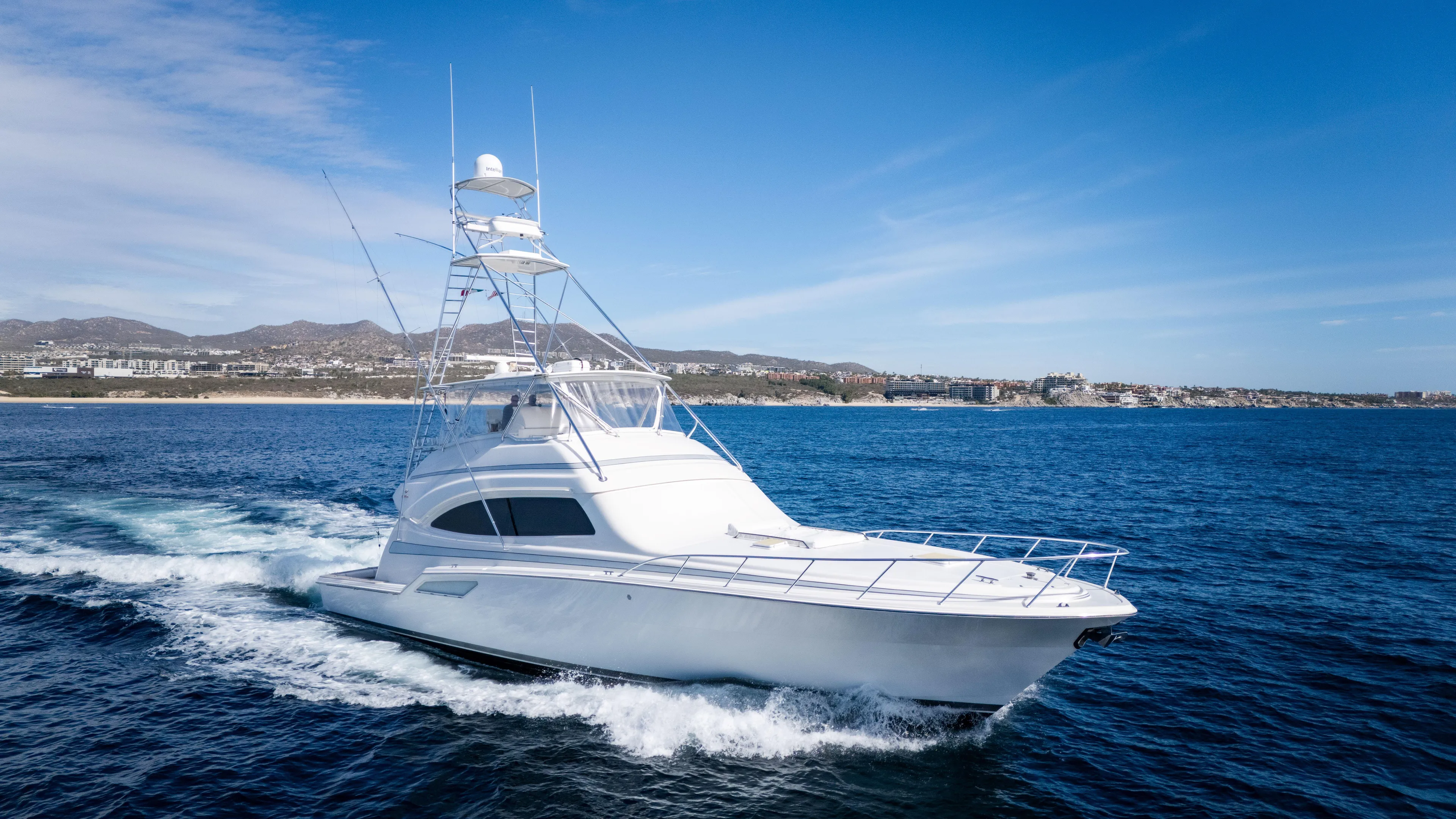 Chill 'n Yacht Photos Pics 2003 Bertram 67 Convertible yacht cruising on open water under clear blue skies.