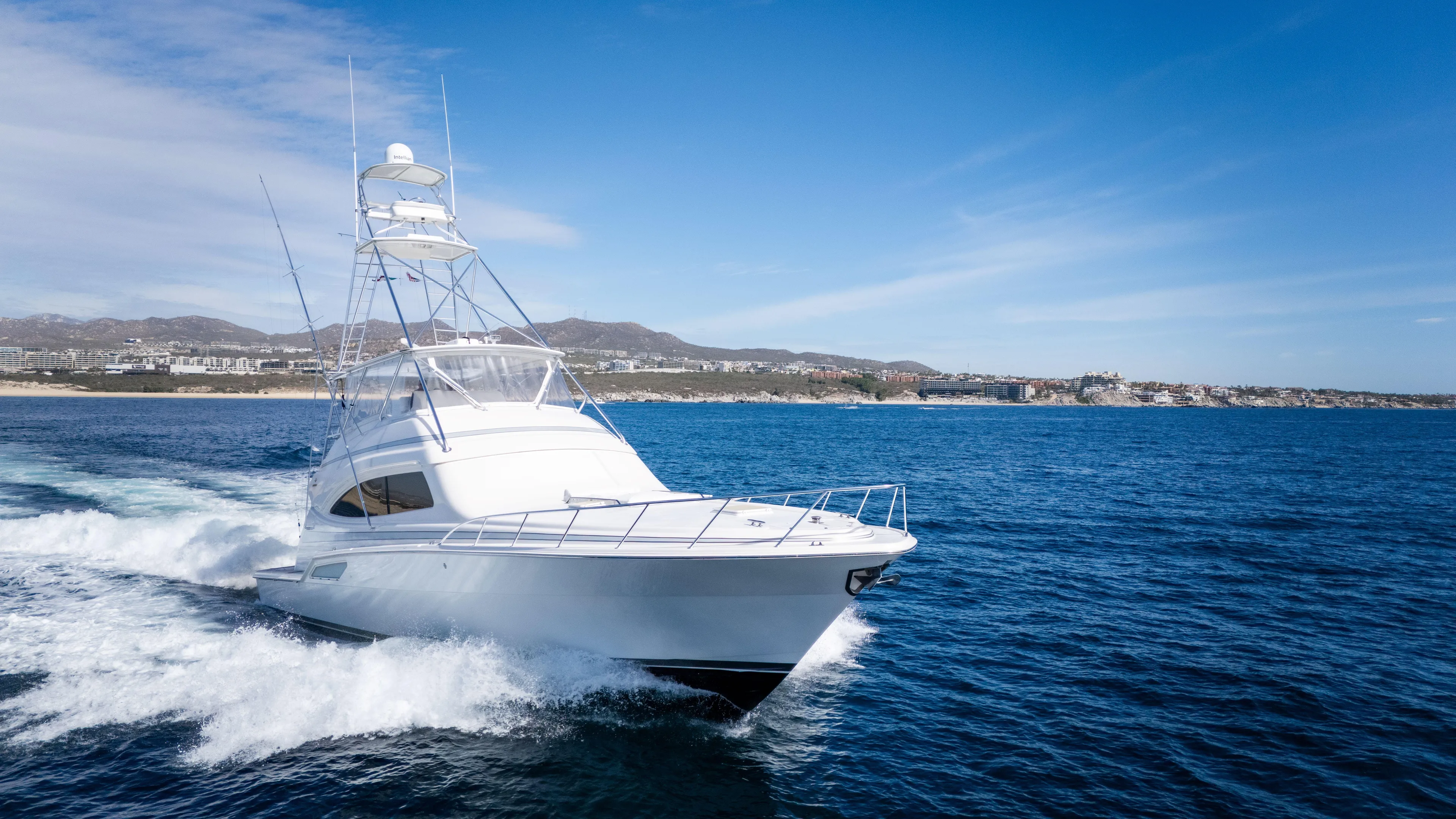 Chill 'n Yacht Photos Pics 2003 Bertram 67 Convertible yacht cruising on open water under a clear blue sky.