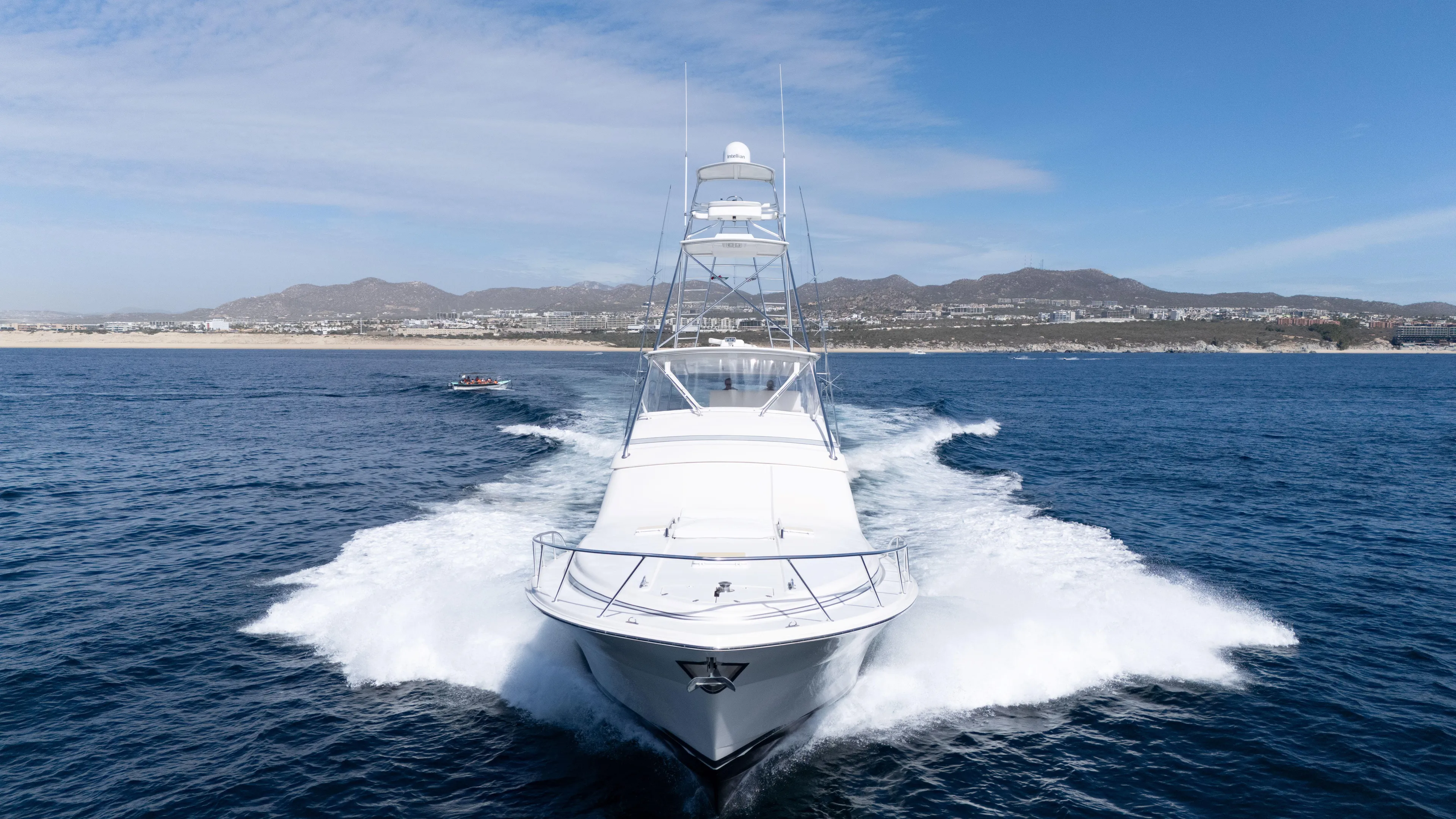 Chill 'n Yacht Photos Pics 2003 Bertram 67 Convertible yacht cruising on open water with scenic mountain backdrop.