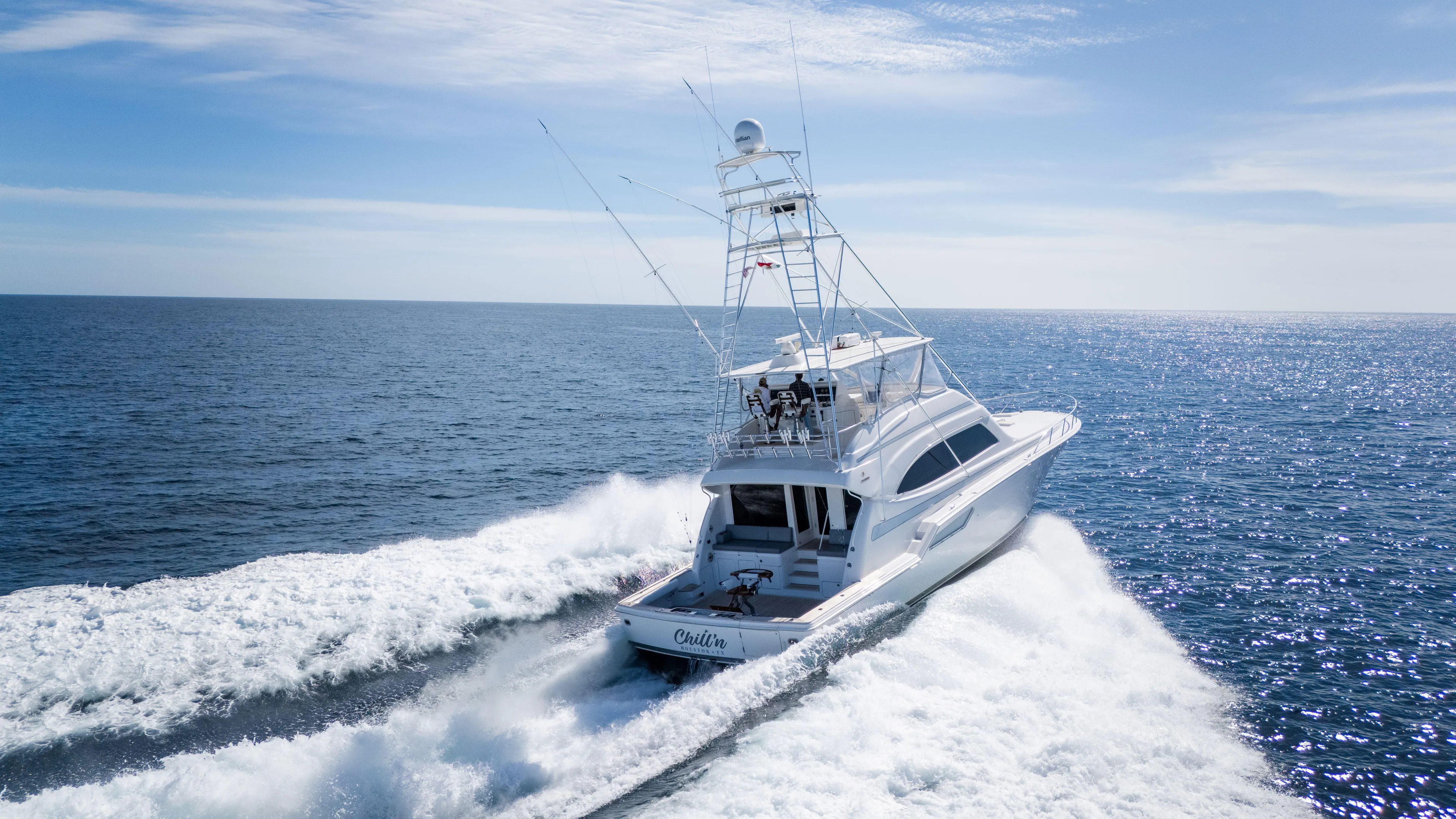Chill 'n Yacht Photos Pics 2003 Bertram 67 Convertible yacht cruising on open sea under clear blue sky.