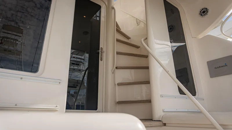 Chill 'n Yacht Photos Pics Staircase and door on a 2003 Bertram 67 Convertible yacht interior.