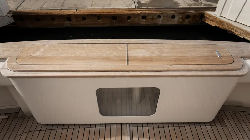 Chill 'n Yacht Photos Pics 2003 Bertram 67 Convertible yacht deck with wooden seating and storage.