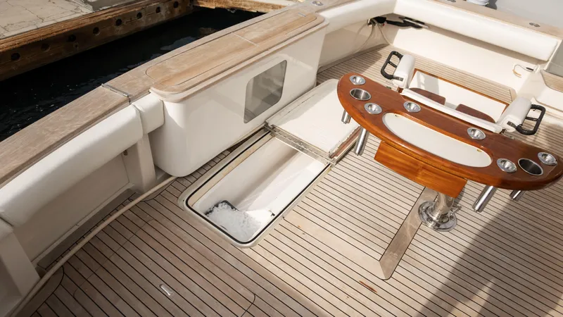 Chill 'n Yacht Photos Pics 2003 Bertram 67 Convertible yacht deck with fishing rod holders and storage compartment.