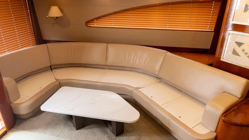 Chill 'n Yacht Photos Pics Luxurious interior of a 2003 Bertram 67 Convertible yacht with beige leather seating.