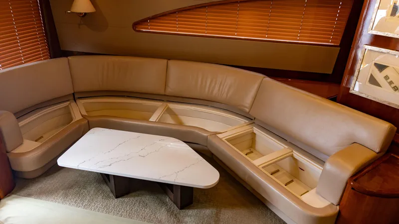 Chill 'n Yacht Photos Pics Luxurious interior of 2003 Bertram 67 Convertible yacht with leather seating and marble table.