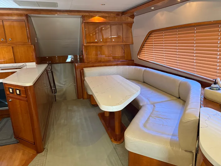 Chill 'n Yacht Photos Pics Luxurious interior of a 2003 Bertram 67 Convertible yacht with elegant wood finishes.