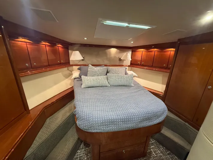 Chill 'n Yacht Photos Pics Luxurious cabin interior of a 2003 Bertram 67 Convertible yacht with cozy bedding.