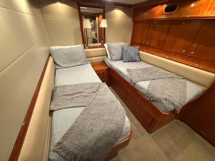 Chill 'n Yacht Photos Pics Luxurious cabin interior of a 2003 Bertram 67 Convertible yacht with twin beds.