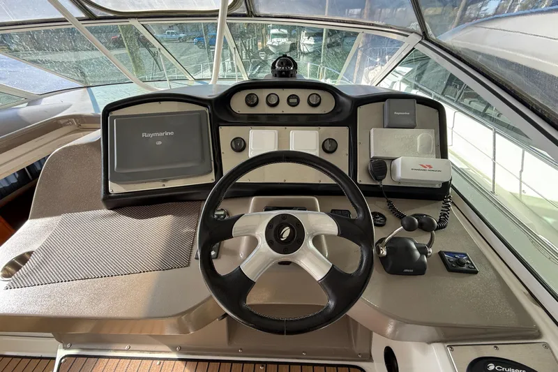  Yacht Photos Pics 2008 Cruisers 455 Motor Yacht helm with steering wheel, navigation equipment, and control panel.