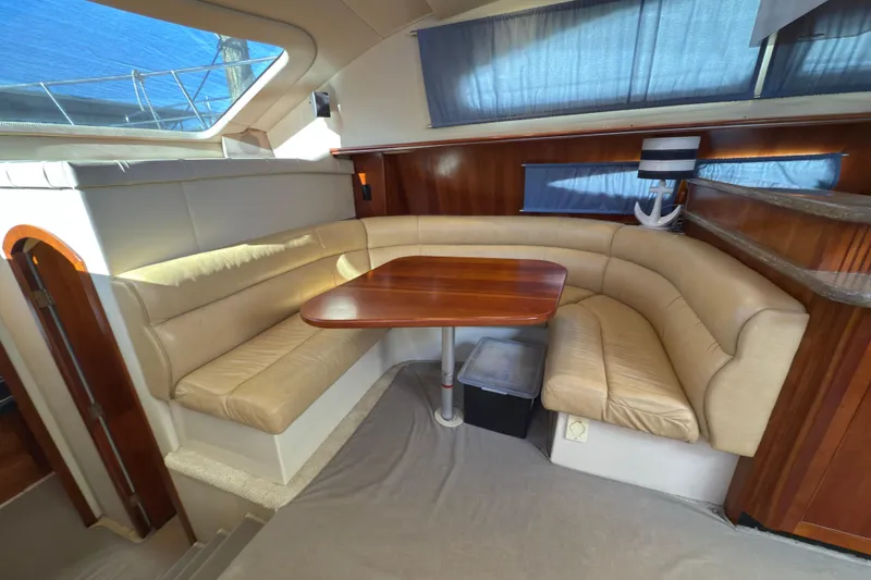  Yacht Photos Pics 2008 Cruisers 455 Motor Yacht interior with beige leather seating and wooden table.
