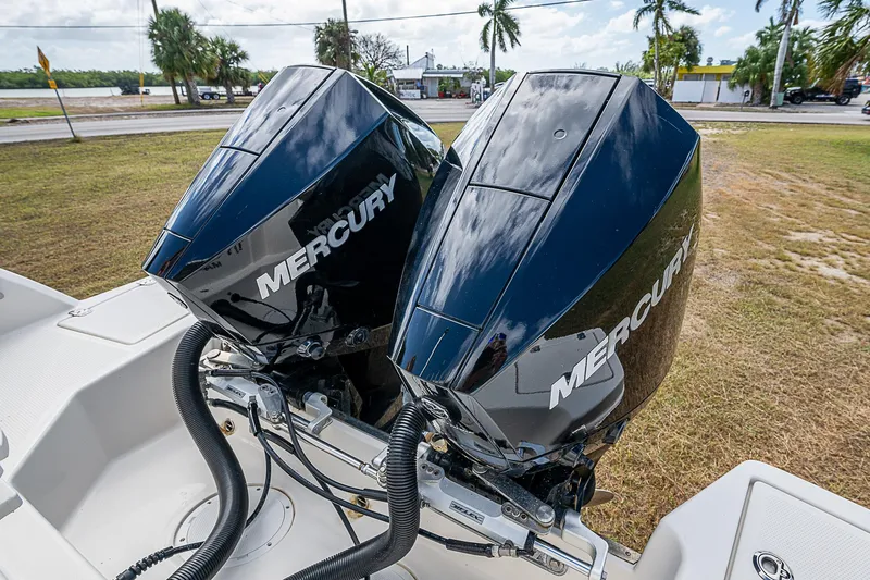  Yacht Photos Pics Twin Mercury outboard engines on 2022 Sailfish 272CC boat, parked on grass.
