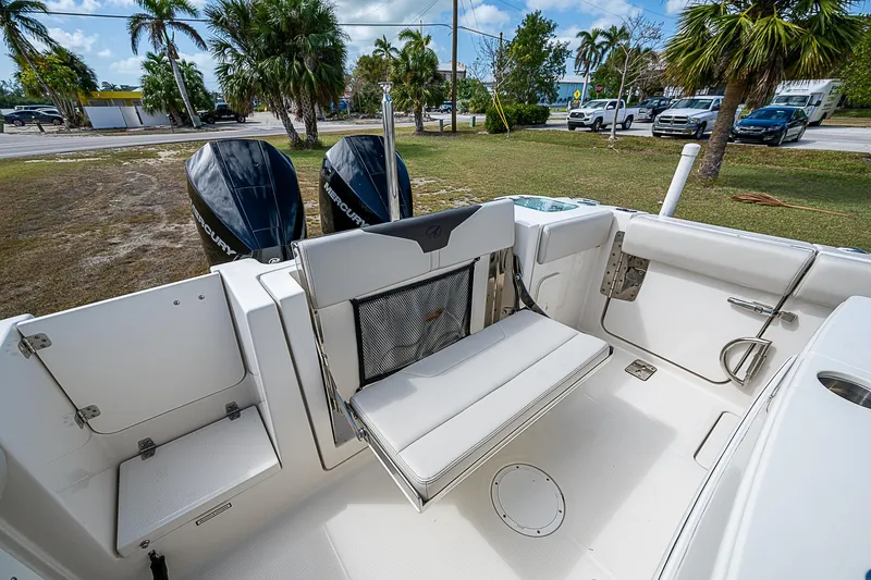  Yacht Photos Pics 2022 Sailfish 272CC boat interior with foldable seating and dual outboard motors.