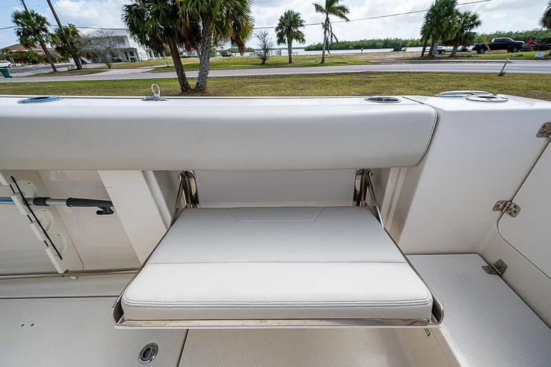  Yacht Photos Pics 2022 Sailfish 272CC boat with foldable seat and coastal background.