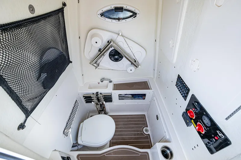  Yacht Photos Pics 2022 Sailfish 272CC boat interior with compact bathroom and storage features.