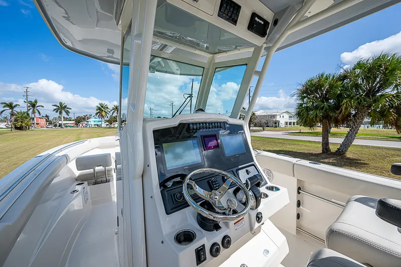  Yacht Photos Pics 2022 Sailfish 272CC boat cockpit with modern controls and steering wheel.