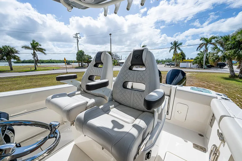  Yacht Photos Pics 2022 Sailfish 272CC boat interior with luxurious seating and steering wheel.
