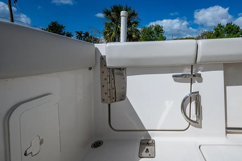  Yacht Photos Pics 2022 Sailfish 272CC boat interior with seating and hardware, under a clear blue sky.