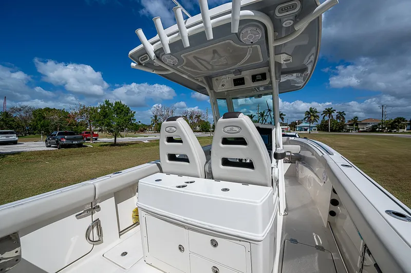  Yacht Photos Pics 2022 Sailfish 272CC boat interior with dual seats and storage under a blue sky.