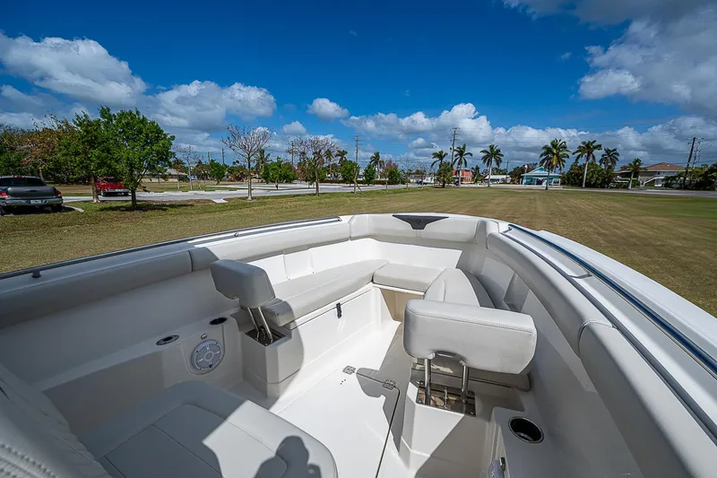  Yacht Photos Pics 2022 Sailfish 272CC boat interior with seating, under a clear blue sky.