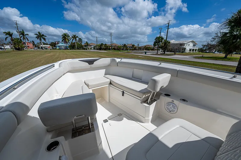  Yacht Photos Pics 2022 Sailfish 272CC boat interior with seating, under a blue sky.