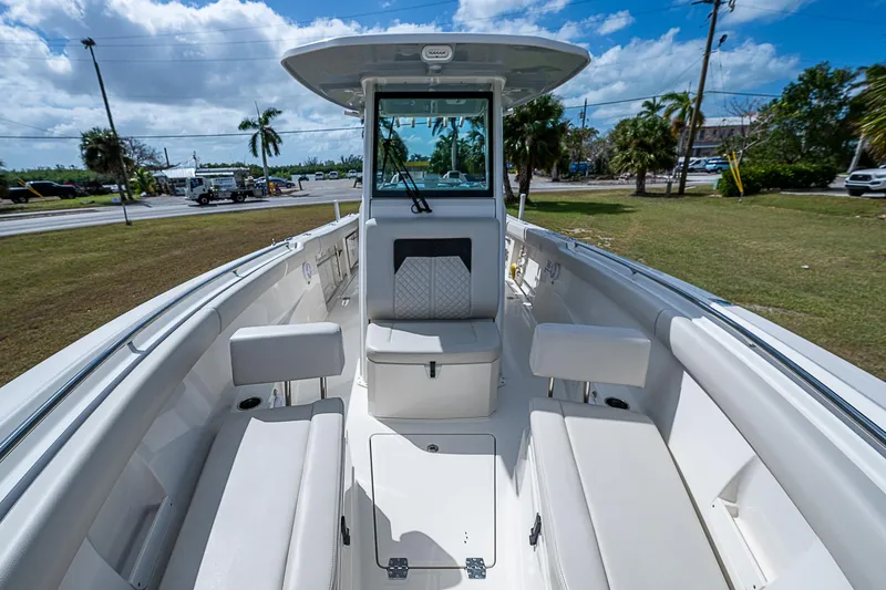  Yacht Photos Pics 2022 Sailfish 272CC boat interior with seating, under a blue sky.