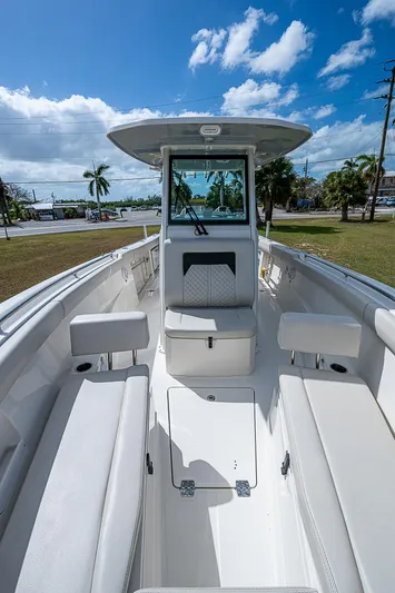  Yacht Photos Pics 2022 Sailfish 272CC boat with spacious seating and modern design under a clear blue sky.