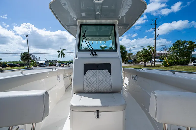  Yacht Photos Pics 2022 Sailfish 272CC boat interior with seating, clear skies, and palm trees in the background.