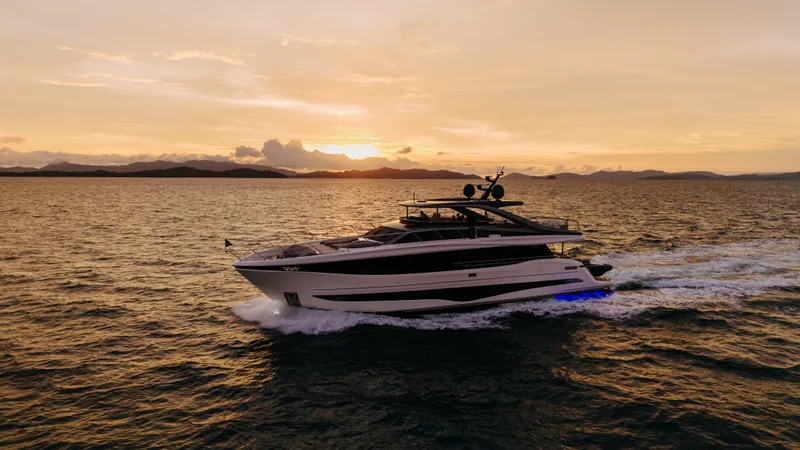  Yacht Photos Pics Luxurious 2023 Princess Y95 yacht cruising at sunset on open sea.