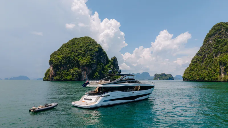  Yacht Photos Pics Luxurious 2023 Princess Y95 yacht cruising near scenic islands under a clear blue sky.