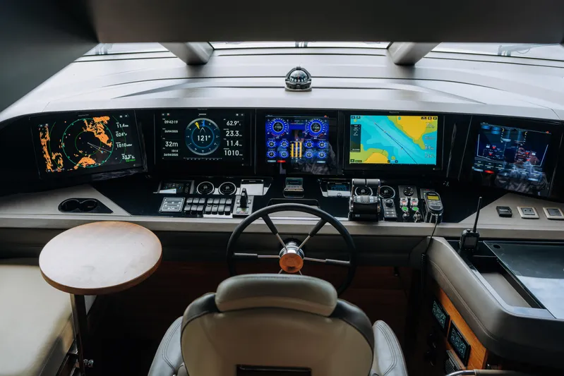  Yacht Photos Pics Control panel of 2023 Princess Y95 yacht with advanced navigation displays and steering wheel.