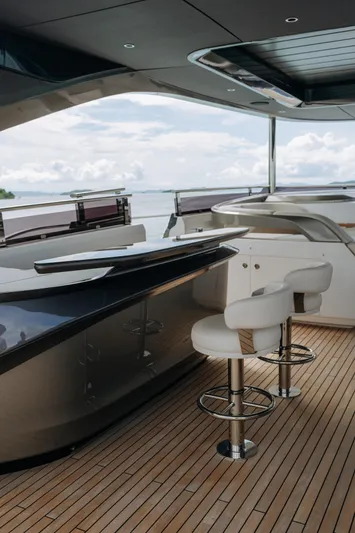  Yacht Photos Pics Luxurious 2023 Princess Y95 yacht interior with sleek bar and modern seating.