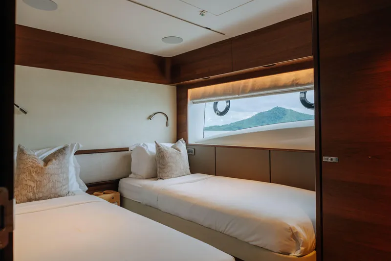  Yacht Photos Pics Luxurious twin cabin on 2023 Princess Y95 yacht with scenic window view.
