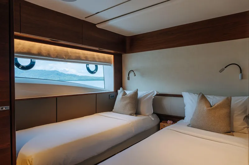  Yacht Photos Pics Luxurious twin cabin interior on 2023 Princess Y95 yacht with scenic window view.