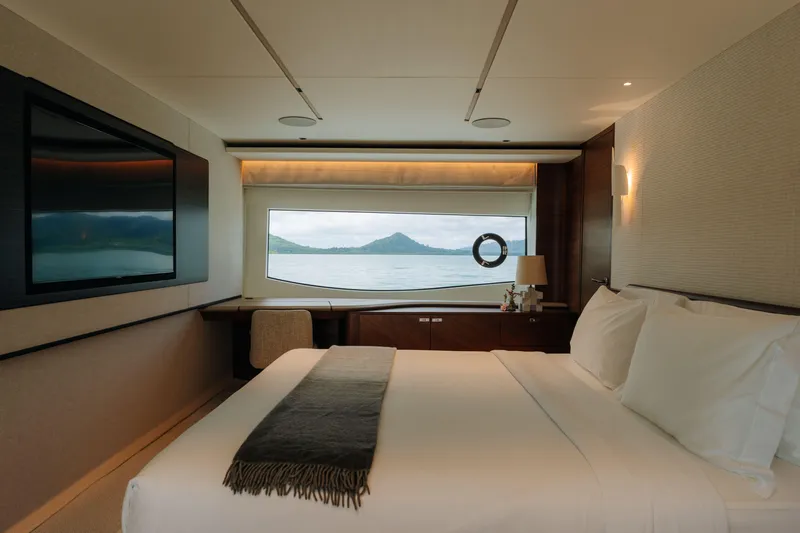  Yacht Photos Pics Luxurious bedroom interior of 2023 Princess Y95 yacht with scenic ocean view.