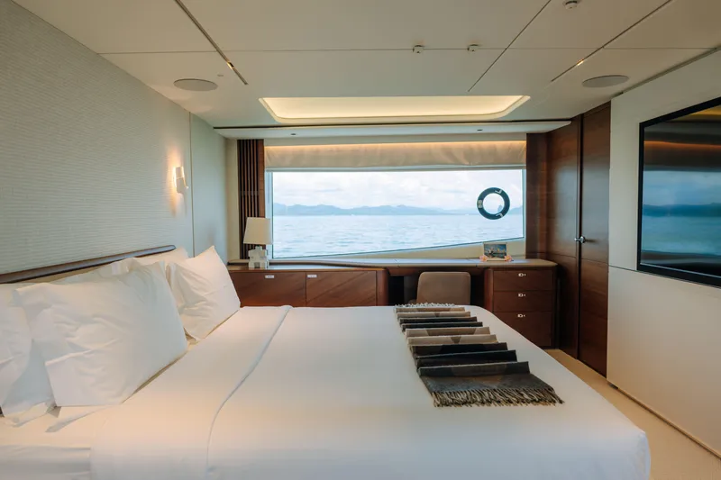  Yacht Photos Pics Luxurious bedroom interior of 2023 Princess Y95 yacht with ocean view.