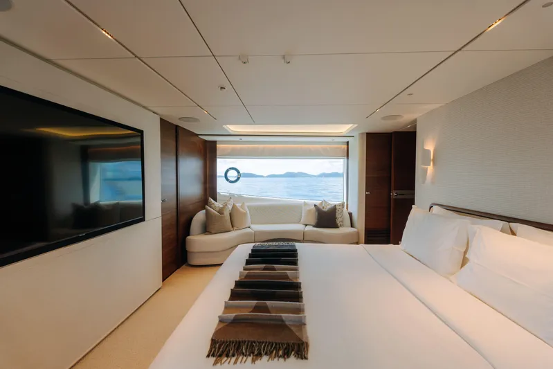  Yacht Photos Pics Luxurious bedroom interior of 2023 Princess Y95 yacht with ocean view.