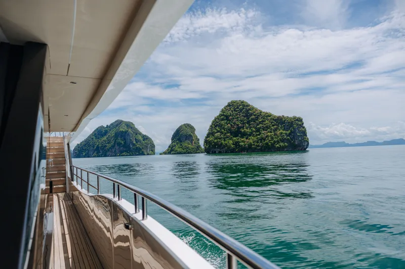  Yacht Photos Pics Luxurious 2023 Princess Y95 yacht cruising near scenic islands under a clear blue sky.