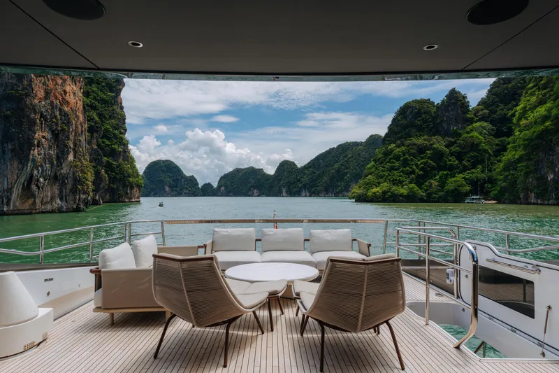  Yacht Photos Pics Luxury yacht Princess Y95 deck with scenic ocean and lush cliffs view, 2023 model.