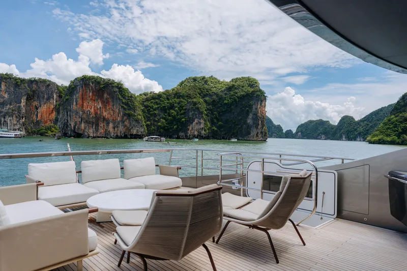  Yacht Photos Pics Luxurious 2023 Princess Y95 yacht deck with scenic ocean and cliffs view.