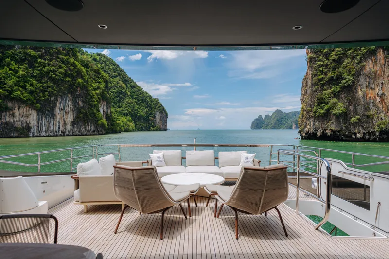  Yacht Photos Pics Luxurious 2023 Princess Y95 yacht deck with stunning ocean and cliff views.